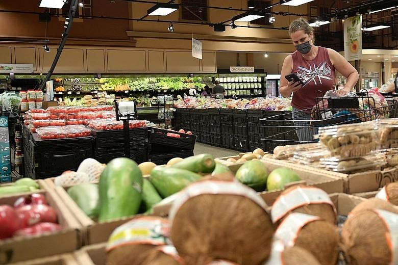 A gig economy worker with grocery delivery firm Instacart at work in a supermarket in the United States. AI-powered organisations, says the writer, are run by a small cohort of highly paid employees, supported by sophisticated automation and potentia