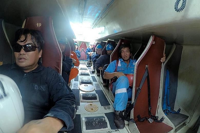 Filipino seamen on board a 22,000-tonne tanker. More than 400,000 seafarers around the world have had to remain on board their ships for about a year or longer because of the coronavirus pandemic. Singapore doctor Charles Johnson (in red T-shirt), me