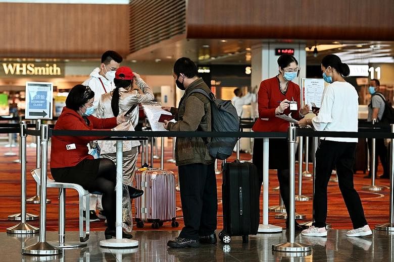 Passengers leaving for China from the departure hall of Changi Airport Terminal 1 on Wednesday. Previous iterations of China's policies stipulated that travellers would need to test negative only by a "nucleic acid test", a tool that hunts for the ge