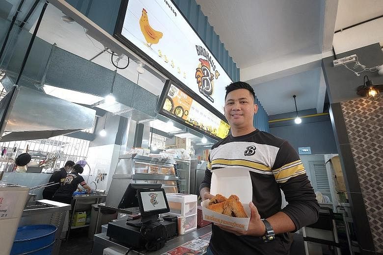 ITE Technical Diploma in Culinary Arts graduate Shah Indra Jasni at his fried chicken stall in Bukit Merah. He says his time in ITE helped him tackle problems and be forward-thinking. ST PHOTO: GAVIN FOO