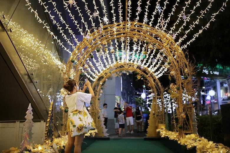 The decorations may have been scaled down, but malls show the Christmas spirit is still alive in Orchard Road with touches such as the huge Christmas tree outside Paragon (left), the lights outside Orchard Central (below, left) and the reindeer sculp