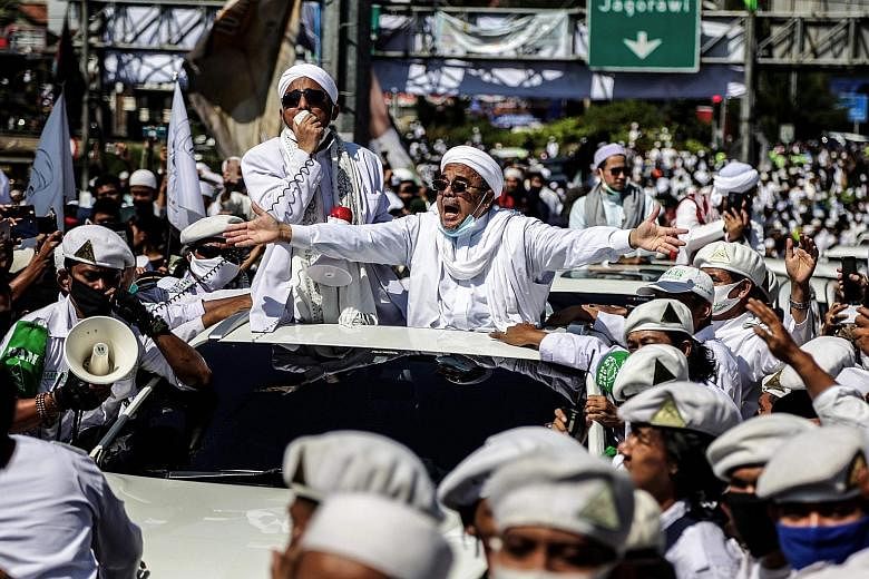 Radical Indonesian cleric Habib Rizieq Shihab gesturing to supporters as he arrived to inaugurate a mosque in Bogor city last Friday. With Indonesia entering its first recession since 1998 due to the coronavirus pandemic, Rizieq is well placed to con