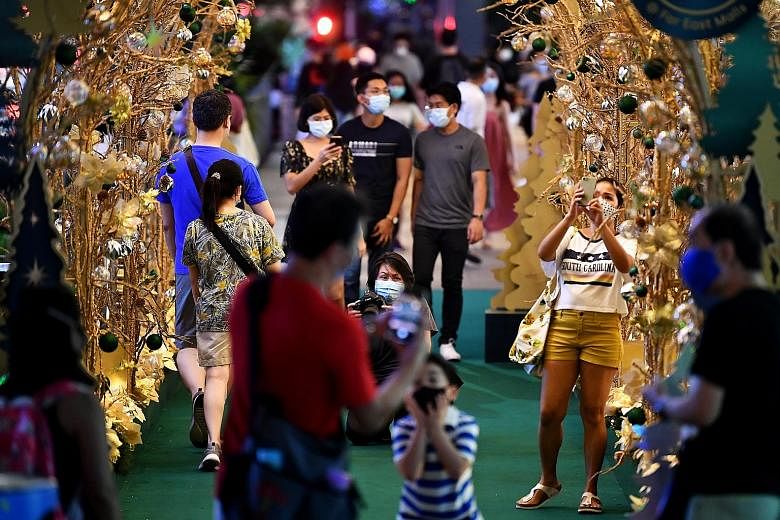 People out and about near Orchard Central last Saturday, enjoying the Christmas decorations. Yesterday marked the sixth day in a row that all new infections were imported, with no community cases and no cases from workers' dormitories.