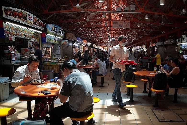 Above: Diners at Maxwell Food Centre yesterday. The decision on whether to include Singapore's hawker culture on Unesco's intangible cultural heritage list will be made next month. Left: Mr Anthony Low, chairman of Boon Lay Hawker Association and vic