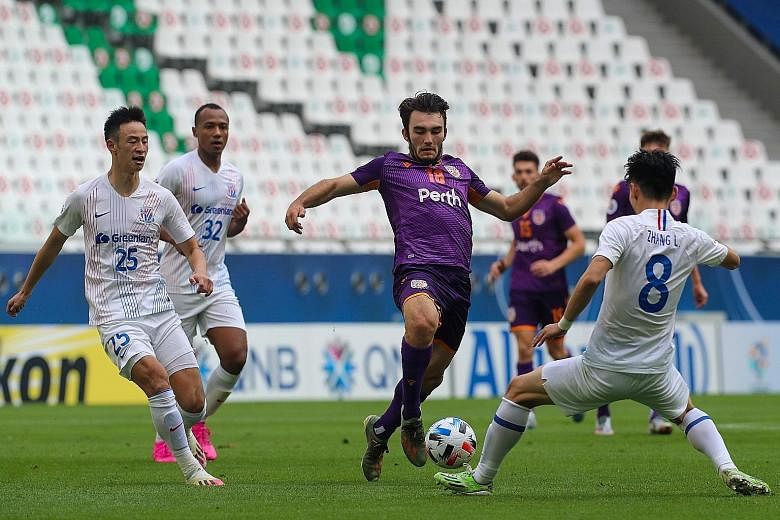 Perth Glory's Nicholas D'Agostino finding no way through the Shanghai Shenhua defence in their Asian Champions League (East) Group F match yesterday. The Chinese side won 2-1 to begin the campaign that was delayed for eight months.