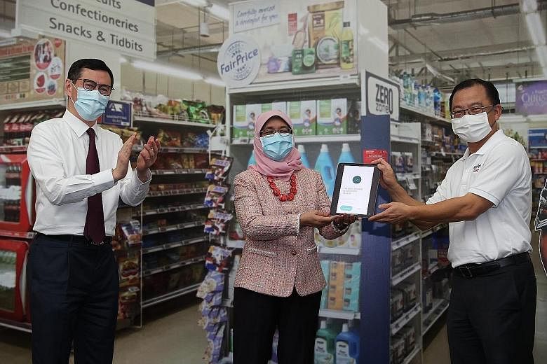 President Halimah Yacob made the first donation of $40 to The Boys' Brigade Share-a-Gift (BBSG) charity drive by scanning a QR code using a bank app yesterday. With her at the opening ceremony at BB Campus in Ganges Avenue are Prudential Singapore's 
