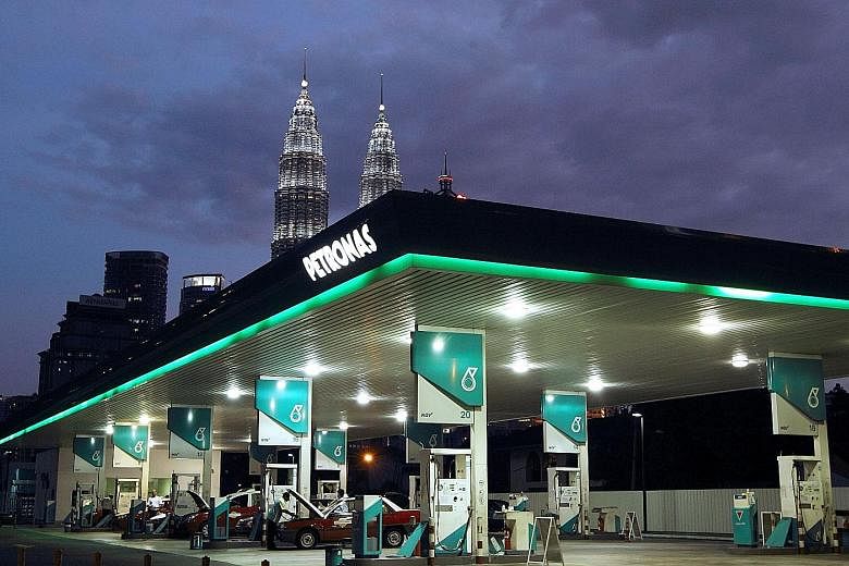 Petronas owns stakes in five listed companies on the local stock exchange. PHOTO: BLOOMBERG