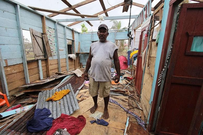 HONDURAS Above: An area around San Pedro Sula flooded by the overflowing Chamelecon river after the passage of Iota on Wednesday. NICARAGUA Far left: A photo from Catholic Relief Services showing a man standing in a house damaged by Iota in Puerto Ca