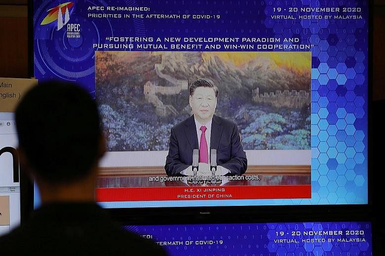 China's President Xi Jinping speaking on screen at the Asia-Pacific Economic Cooperation forum in Kuala Lumpur yesterday. Mr Xi said the region is the "forerunner driving global growth" in a world hit by "multiple challenges".