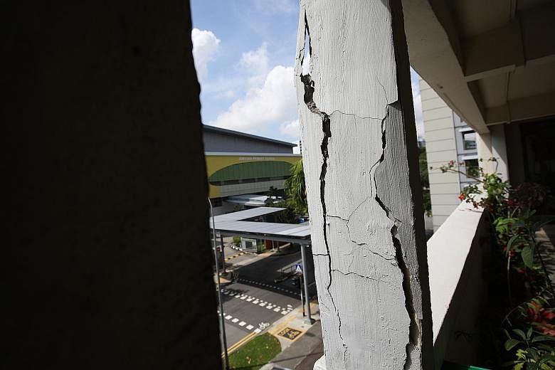 Cracks in the pillars (right) along the fourth-floor corridor of Block 915 Tampines Street 91 have raised fears among residents. They are also worried about falling concrete from the ceiling of the corridor.