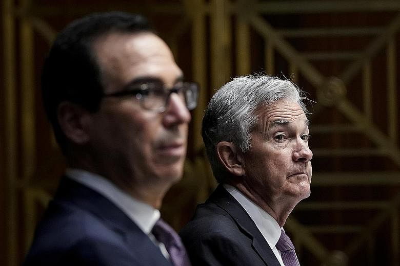 Treasury Secretary Steven Mnuchin (left) and Federal Reserve chair Jerome Powell disagree over whether to keep in place emergency lending facilities designed to shore up the US economy. PHOTO: REUTERS