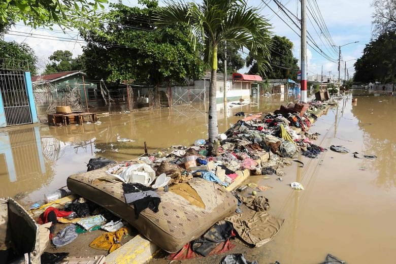 Clothes, a mattress and furniture washed up between two flooded streets in the municipality of La Lima in Honduras yesterday, after heavy rain from Hurricane Iota caused the Chamelecon River to overflow. The number of reported deaths on Thursday rose