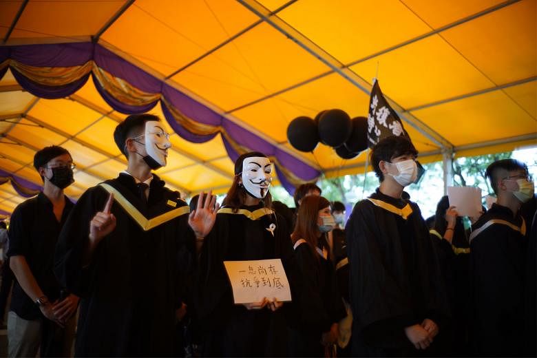 Graduating students from the Chinese University of Hong Kong on Thursday, some of them in white Guy Fawkes masks - made popular by protesters and by the film V For Vendetta. The police said protesters "displayed banners and flags, and chanted slogans