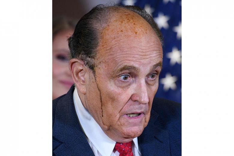 Sweat mixed with hair dye dripped down Mr Rudy Giuliani's temples while he spoke at the Republican National Committee headquarters on Thursday. PHOTO: AGENCE FRANCE-PRESSE