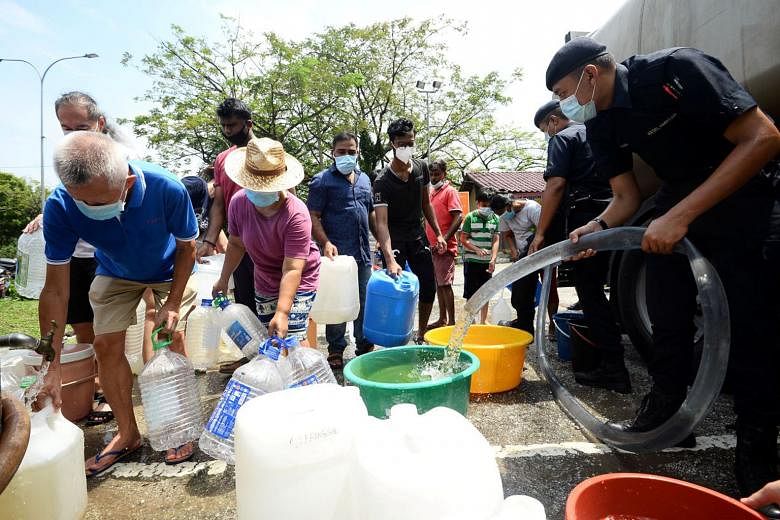 Residents of Puchong Jaya, Selangor, collecting water last month. In at least eight incidents this year, pollutants were dumped into rivers, leading to unscheduled water cuts in Selangor and Kuala Lumpur.