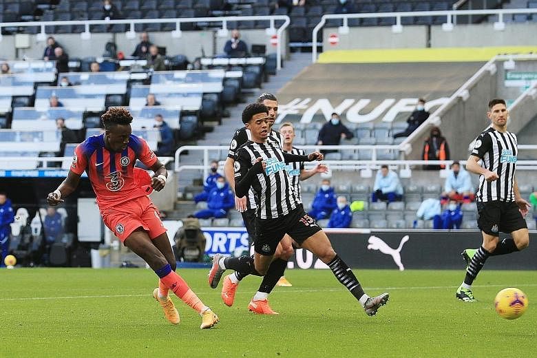Chelsea's Tammy Abraham sealing the three points for his team in yesterday's 2-0 win at Newcastle. It was the Blues' third straight win in the Premier League, provisionally moving them to first in the table.