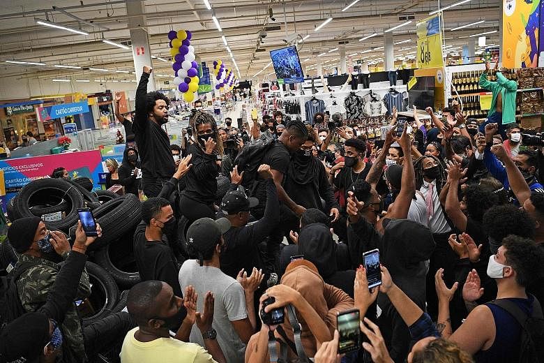 Demonstrators protesting at a Carrefour supermarket in Rio de Janeiro on Friday against the death of a black man beaten by white security guards at one of the chain's branches in Porto Alegre. A video of Thursday night's incident captured on a mobile