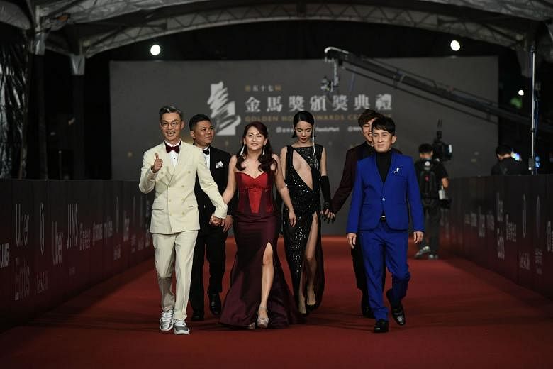 Director Chen Yu-hsun (second from left) and his team at the awards ceremony yesterday, after winning the Best Narrative Feature award for My Missing Valentine. On the red carpet at the Golden Horse Awards in Taipei yesterday were (first row, from le