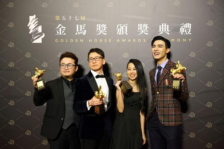 Songwriters (from left) Keon Chia, Tan Boon Wah and Hooi Yuan Teng and actor Edward Chen of Your Name Engraved Herein with the Best Original Film Song award yesterday. PHOTO: REUTERS