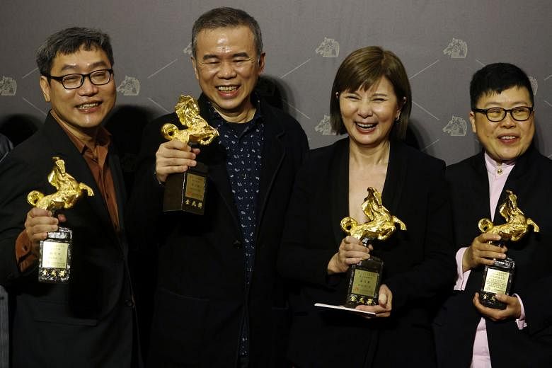 Director Chen Yu-hsun (second from left) and his team at the awards ceremony yesterday, after winning the Best Narrative Feature award for My Missing Valentine. On the red carpet at the Golden Horse Awards in Taipei yesterday were (first row, from le