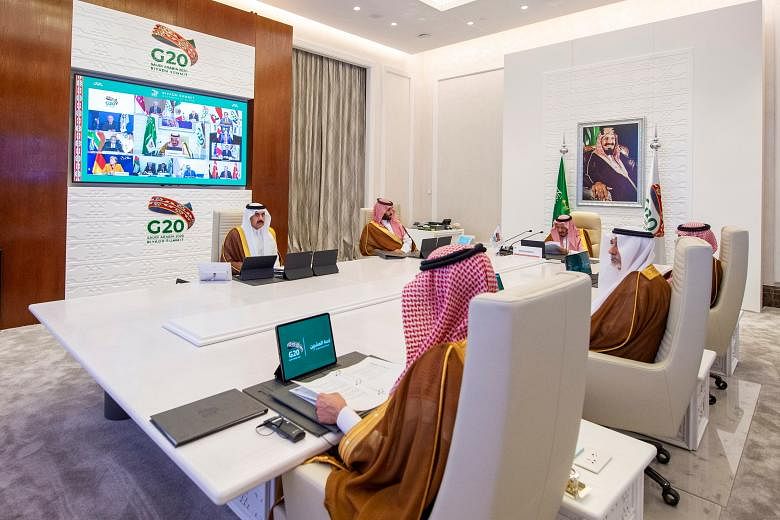 Saudi Arabia's King Salman bin Abdulaziz Al Saud (head of table) giving a speech during an opening session of the virtual Group of 20 summit in Riyadh yesterday. World leaders are huddling virtually in the two-day meeting as international efforts int