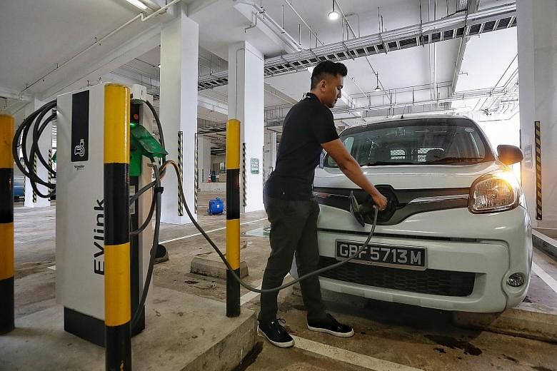 Singapore is growing its network of electric vehicle charging points. The writer says the use of mobile chargers that operate like power banks for smartphones can help prevent long queues at charging stations. ST PHOTO: KEVIN LIM