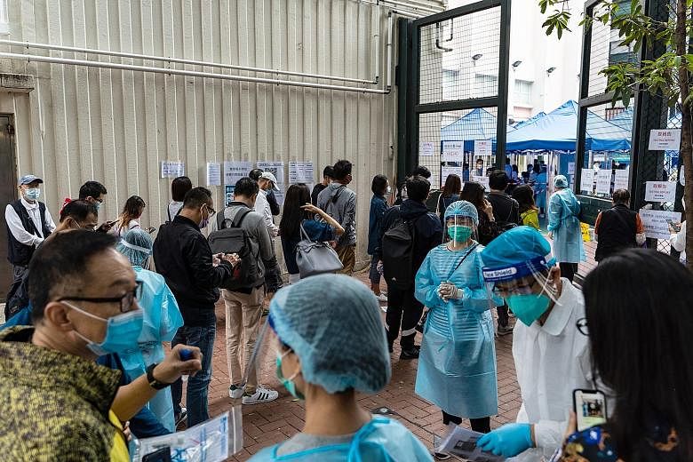 People waiting outside a community testing centre in the Yau Ma Tei district of Hong Kong yesterday. A recent uptick in Covid-19 cases in Hong Kong proved enough to delay the start of the air corridor between Hong Kong and Singapore by two weeks, das