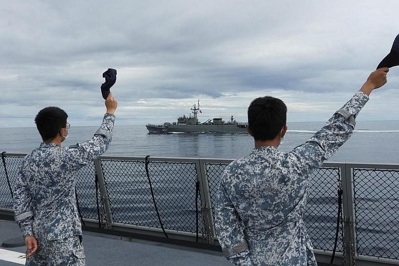 Republic of Singapore Navy sailors on the deck of the RSS Intrepid waving during the sail-past to conclude the maritime exercise. Due to the Covid-19 pandemic, the crew of the RSS Intrepid and RSS Endeavour were isolated and tested negative for the v