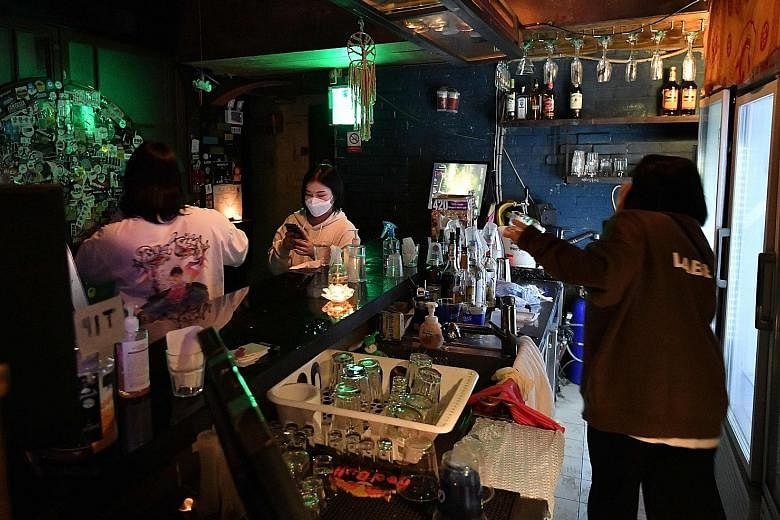 People at an underground music club in the Hongdae nightlife district of Seoul. Under Level 2 social distancing that is set to take effect today in Seoul and greater Seoul, five types of major entertainment facilities, including clubs and bars, will 