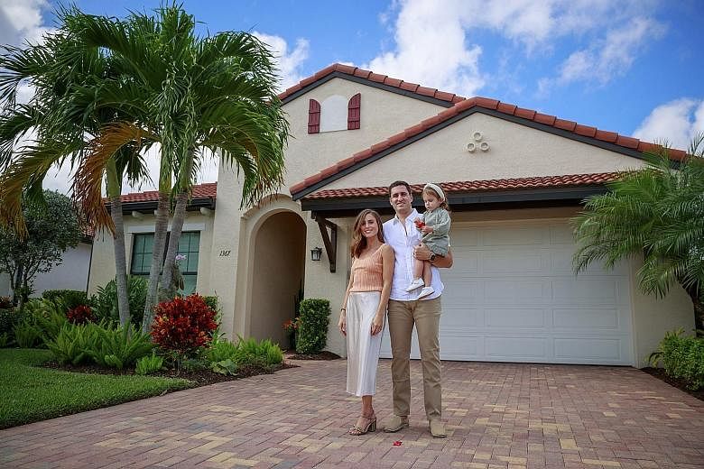Ms Melanie Granuzzo with her husband Brandon and their daughter Amelia outside their vacation home in Naples, Florida, earlier this month. Home owners renting out their Florida abodes for winter are seeing more young people instead of the usual retir