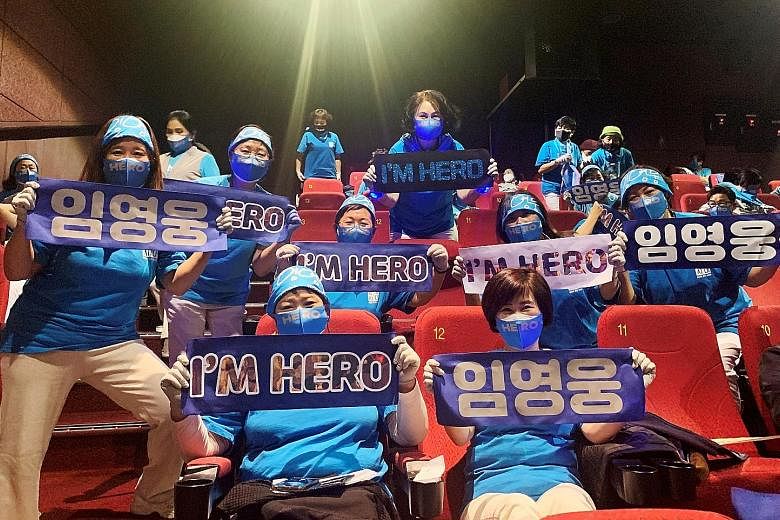 Fans of South Korean singer Lim Young-woong posing for photographs with banners bearing his name before watching Mr Trot: The Movie, at a theatre in Gunpo, South Korea, last month.