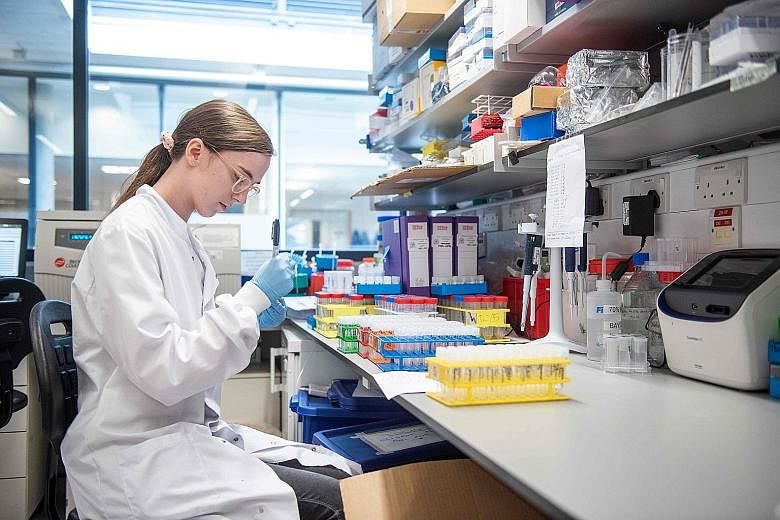 A technician working on the University of Oxford's Covid-19 candidate vaccine. The announcement of a vaccine may drive market optimism, but does not reopen economies for now. "The vaccine gives more of a vision for what may be late next year, and wha