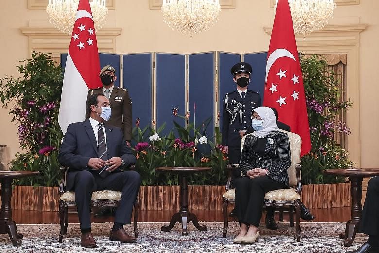 Indonesia's Ambassador to Singapore, Mr Suryo Pratomo (above, left), and Egypt's Ambassador to Singapore, Mr Mahmoud Assem ElMaghraby, with President Halimah Yacob yesterday.