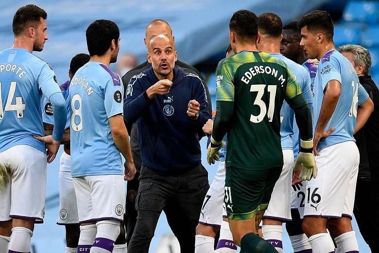 Manchester City manager Pep Guardiola speaking to his players during their English Premier League win over Liverpool at the Etihad Stadium in July. The Spaniard admits that he needs a new game plan to get his side scoring again. PHOTO: AGENCE FRANCE-