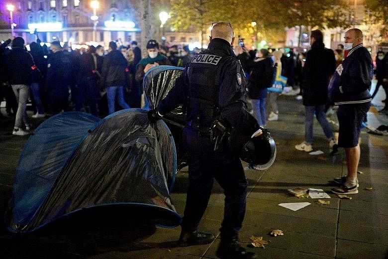 Volunteers had set up tents for migrants at the Place de la Republique (above) in central Paris, but police moved in on Monday to clear the camp (right). PHOTOS: AGENCE FRANCE-PRESSE