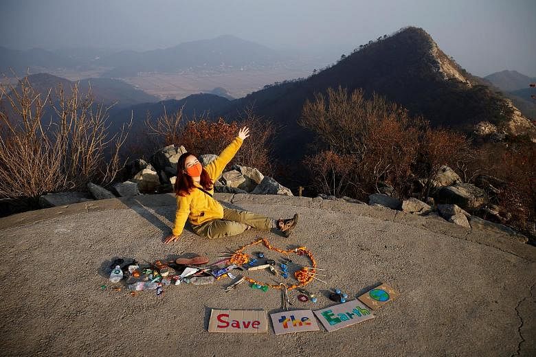 Hiker Kim Kang-eun with junk art made from litter collected by members of Clean Hikers, a group dedicated to picking up rubbish from South Korea's mountain parks.