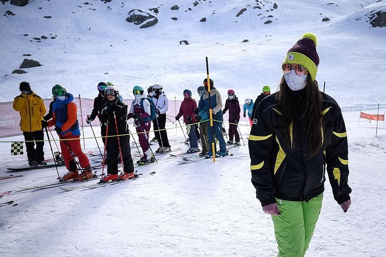 Some skiers at the Alpine resort in Verbier, Switzerland wear masks as they queue for the ski lift. Resorts in Italy and France are set to stay shut.