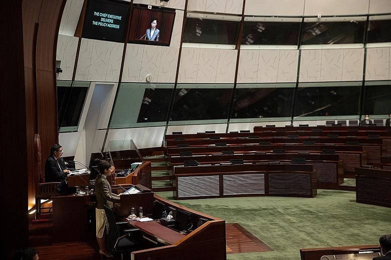 Hong Kong's Chief Executive Carrie Lam giving her policy address in front of empty seats that used to be occupied by opposition lawmakers in the Legislative Council. PHOTO: EPA-EFE