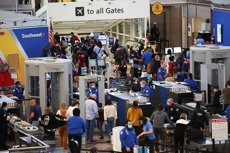 Travellers at a security checkpoint at an airport in Denver, Colorado, on Tuesday, ahead of the Thanksgiving holiday long weekend, which starts today. Although fewer in number than is typical, millions of Americans have flocked to airports and highwa