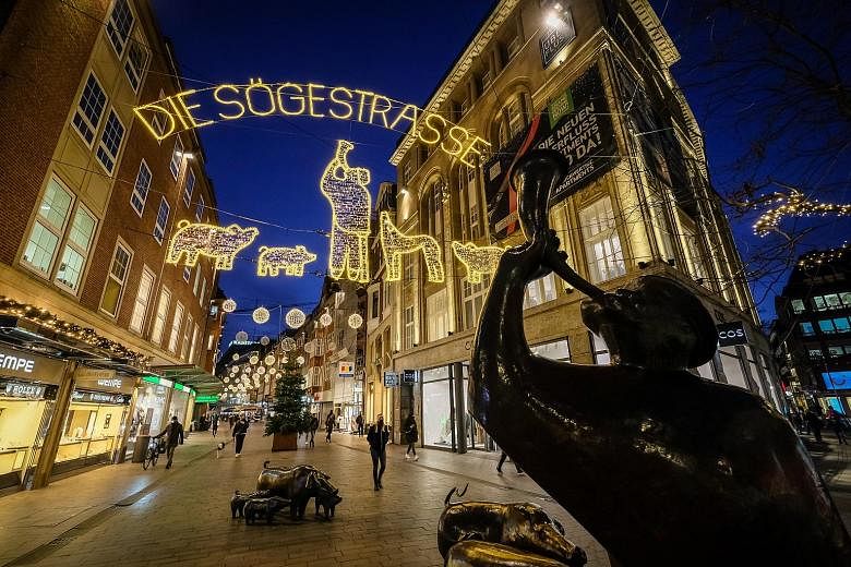 Christmas lights at the deserted Soegestrasse shopping street in Bremen, Germany, on Wednesday. The country extended a partial lockdown and is among those in Europe that have announced restrictions over the holiday period.