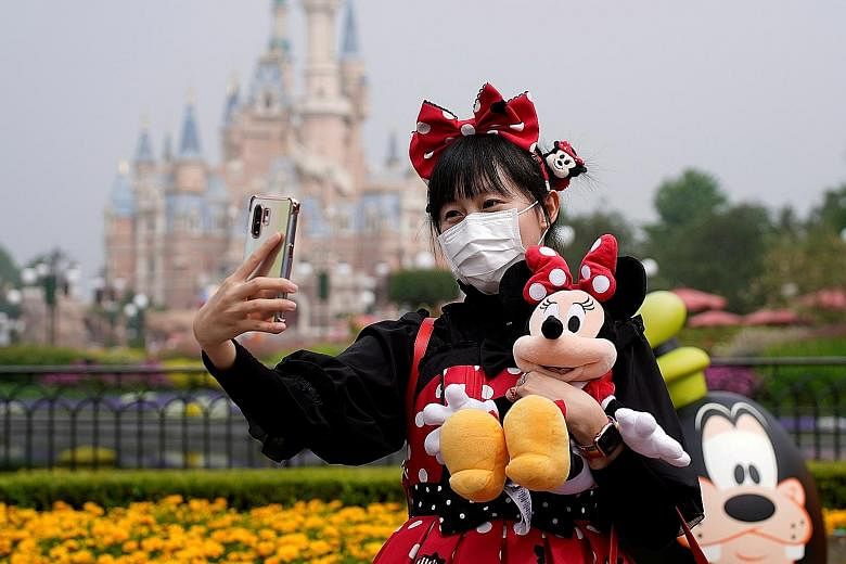 Walt Disney Co's theme parks in Shanghai (above), Hong Kong and Tokyo remain open. PHOTO: REUTERS