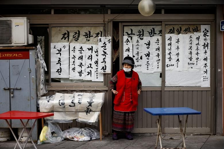 A restaurant owner waiting for customers in Seoul on Wednesday. The government reimposed tough social distancing rules on the capital and surrounding regions this week, only a month after they had been eased. Health officials have expressed regret ab