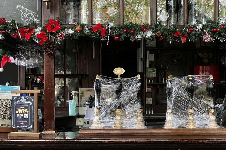 A pub in London remains shut for business, with beer pumps covered in clingfilm. The city's Mayor Sadiq Khan has lobbied for London to be in tier two, warning that a tier three alert rating would be "catastrophic" for the capital's hospitality indust