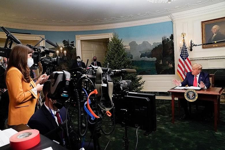 US President Donald Trump talking to reporters at the White House after he spoke by video link, because of the pandemic, to members of the military on Thursday for the Thanksgiving holiday.