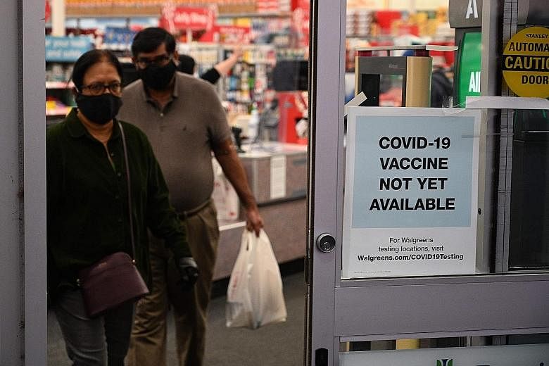 A sign on the entrance to a pharmacy in Burbank, California, earlier this week informs customers that the Covid-19 vaccine is not yet available. While Britain has hastened the regulatory approval process, clearance from the US Food and Drug Administr