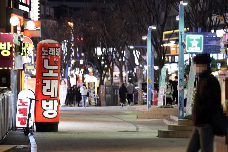Crowds were sparse yesterday in Hongdae, usually one of the busiest entertainment districts in Seoul. Of South Korea's latest 569 cases, 525 were domestically transmitted and more than 64 per cent of those were from the Seoul metropolitan area. PHOTO