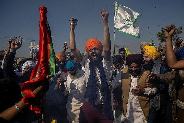 Indian farmers at New Delhi's Singhu border with Haryana state yesterday, protesting against agricultural deregulation laws enacted in September by Prime Minister Narendra Modi's government that they fear will leave them vulnerable to big business an