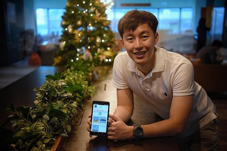 Taby Technologies co-founder Yap Jun Yi with the company's personal finance app. ST PHOTO: MARK CHEONG