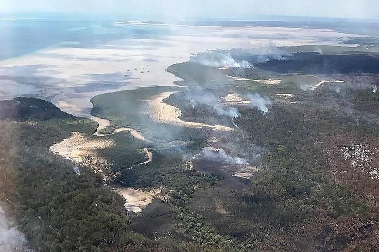 A photo from the Queensland Fire and Emergency Services showing an aerial view of bush fires on Fraser Island, off Australia's east coast. The fire on the world's largest sand island has been raging for more than six weeks and is consuming large swat