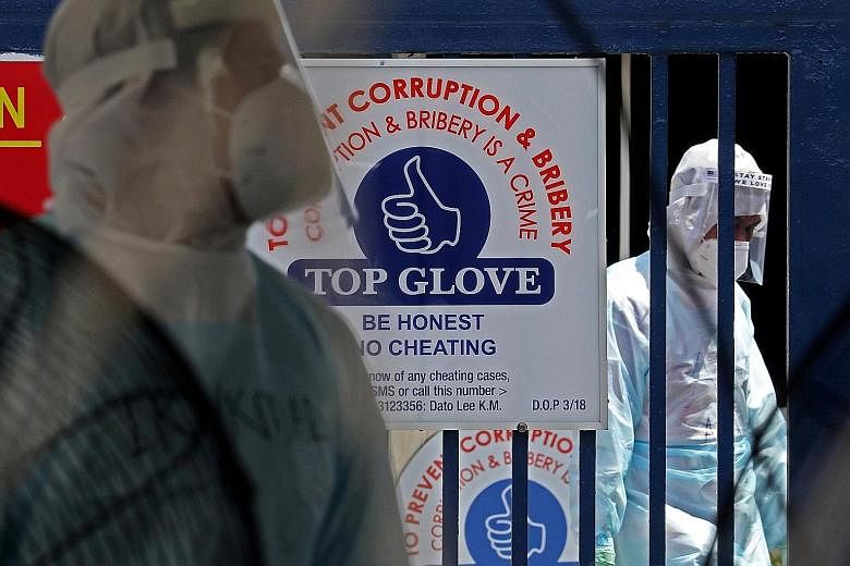 Medical workers at a Top Glove hostel under lockdown in Klang last month. Recent enforcement operations, prompted by a Covid-19 outbreak at a Top Glove factory, found living spaces to be cramped and uncomfortable, with poor ventilation and a lack of 